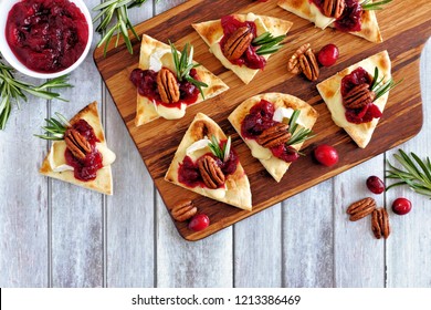 Holiday Flatbread Appetizers With Cranberries, Pecans And Brie Cheese. Top View Table Scene On A Wooden Platter.