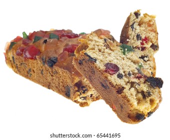 Holiday Fruit Cake With Slices Isolated On White With A Clipping Path.