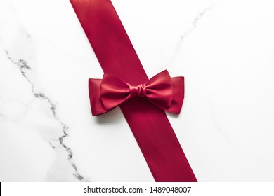 Holiday Gift, Decoration And Sale Promotion Concept - Bordeaux Silk Ribbon On Marble Background, Flatlay