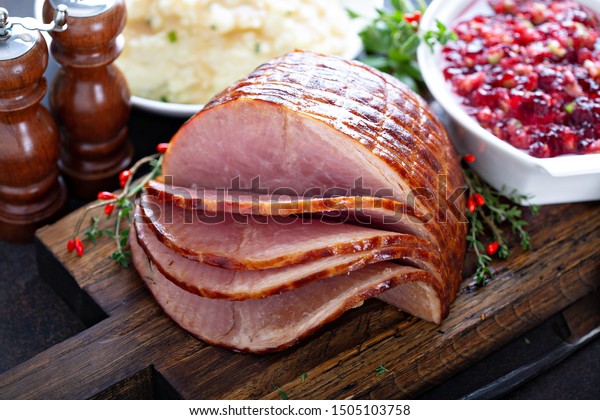 Holiday glazed ham for Christmas dinner with\
cranberry sauce