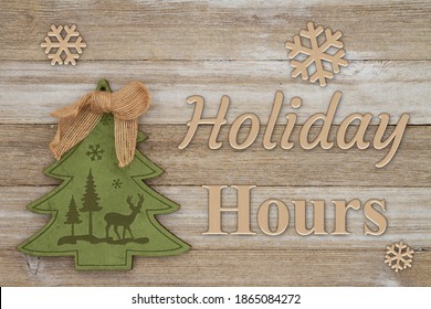 Holiday Hours Message With Christmas Tree With Grunge Wood Background