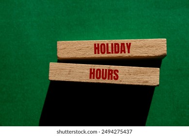 Holiday hours message written on wooden blocks on green background. Conceptual holiday hours symbol. Copy space. - Powered by Shutterstock