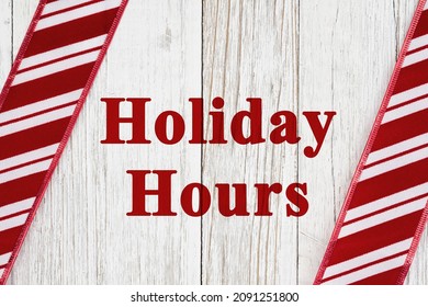 Holiday Hours Sign With Red And White Candy Cane Striped Border On Weathered Wood