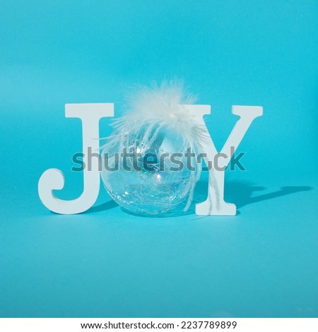 Holiday idea. Joy symbol made of Christmas decoration and wood letters. 