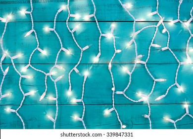 Holiday Lights On Antique Rustic Teal Blue Wood Background; Christmas Background With Blue Copy Space
