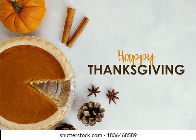 Holiday Meal Elements With Happy Thanksgiving Text By Pumpkin Pie Background.