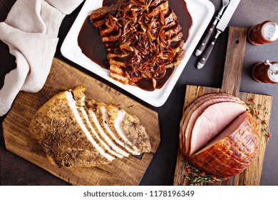 Holiday Meats Shot From Above With Roasted Turkey, Sliced Ham And Brisket