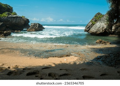 Holiday moments on beaches dominated by coral, white sand and crashing waves. The beautiful panorama of the beach is still natural and there are no other tourists in the middle of the day - Shutterstock ID 2365346705