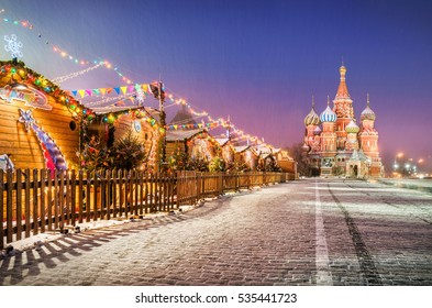 Holiday New Year's Red Square And St. Basil's Cathedral In The Morning Light Of Lanterns And Snow. On Signs It Is Written: Marketplace On The Red Square.