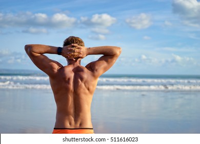 Holiday On The Beach. Back View Of Relaxed Young Muscular Man Enjoying Sea View.