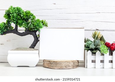 Holiday Party Invitation Mockup. Horizontal White Card 5x7 On A Table With Flowers.