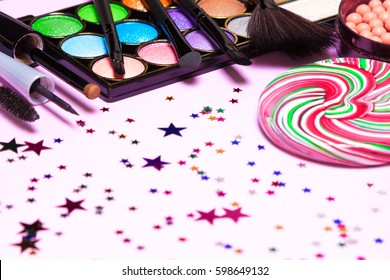 Holiday Party Makeup Cosmetics With Lollipop And Confetti. Shallow Depth Of Field