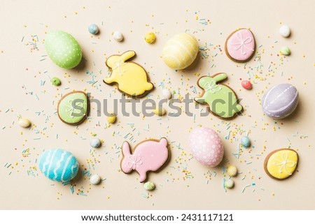holiday preparation Multi colors Easter eggs with cookies on colored background . Pastel color Easter eggs. holiday concept with copy space.