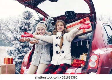 Holiday Preparations. Pre Teen Children Enjoy Many Christmas Presents In Car Trunk. Cold Winter, Snow Weather.