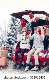 Holiday Preparations. Pre Teen Children Enjoy Many Christmas Presents In Car Trunk. Cold Winter, Snow Weather.