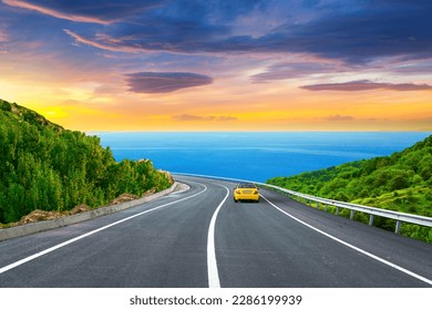 holiday road landscape in summer. car driving on the road of europe. Highway landscape at colorful sunset. Beautiful nature scenery on ocean beach. Road view on the sea. coastal freeway in vacation.