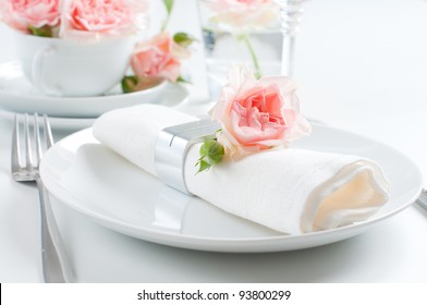 Holiday romantic table setting with pink roses on a white background - Powered by Shutterstock