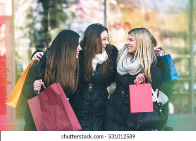 Holiday shopping girls in the street with bags