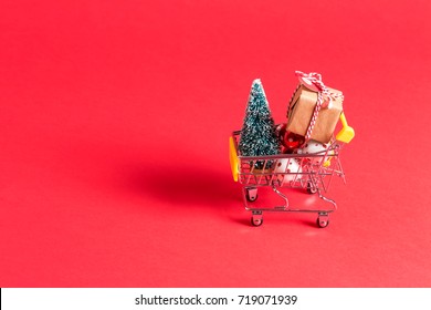 Holiday shopping theme with shopping cart filled with giftboxes