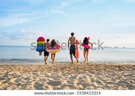  Holiday summer beach party with friends at sea .Party beach family and friends  jumping on the beach. lifestyle people vacation holiday on beach