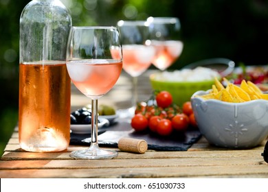 Holiday Summer Brunch Party Table Outdoor In A House Backyard With Appetizer, Glass Of Rose Wine, Fresh Drink And Organic Vegetables  