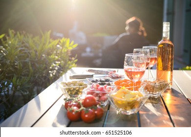 Holiday Summer Brunch Party Table Outdoor In A House Backyard With Appetizer, Glass Of Rosé Wine, Fresh Drink And Organic Vegetables  