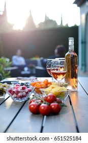 Holiday Summer Brunch Party Table Outdoor In A House Backyard With Appetizer, Glass Of Rosé Wine, Fresh Drink And Organic Vegetables  