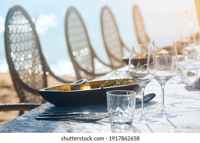 Holiday Table Decor Wine Glasses And Table Setting. Preparing For An Open-air Party In The Beach.