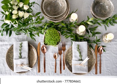 Holiday table setting with Linen napkins and rose gold cutlery. Close up