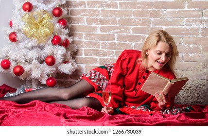 Holiday Tips For Introvert. Celebrate Christmas Without Social Obligations. Woman Hold Glass Champagne And Book. Girl Relax Near Christmas Tree. Alone On Christmas. Celebrating Christmas As Introvert.