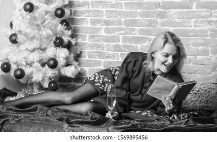 Holiday Tips For Introvert. Celebrate Christmas Without Social Obligations. Woman Hold Glass Champagne And Book. Girl Relax Near Christmas Tree. Alone On Christmas. Celebrating Christmas As Introvert.