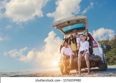 Holiday and travel family concept, Summer vacations . Happy family enjoying road trip with their favorite car. Parents and children are traveling the way to the sea or ocean or river. - Shutterstock ID 1576559980