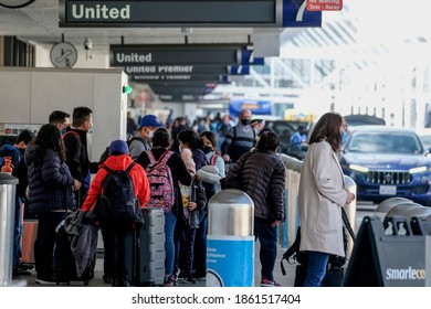 Holiday travelers arrive at the Los Angeles International Airport (LAX), in Los Angeles on Wednesday, Nov. 25, 2020.