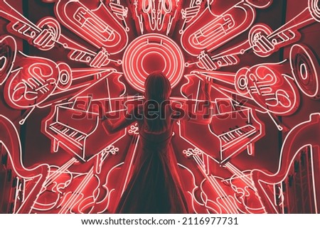 A holiday window display of a female music conductor surrounded by many instruments 
