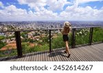 Holidays in Belo Horizonte, Brazil. Panoramic banner view of traveler girl enjoying cityscape of the metropolitan area of Belo Horizonte, Minas Gerais, Brazil.