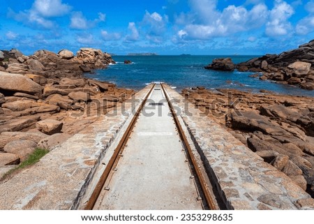 Holidays in Brittany, France: Hiking the grandiose customs officers' path, Sentier des Douaniers on the Côte de Granit Rose coast between Perros-Guirec and Ploumanac'h - slipway rails for lifeboats