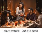 holidays and celebration concept - multiethnic group of happy friends having christmas dinner at home