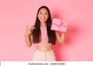 Holidays, Celebration And Lifestyle Concept. Cute Cheerful Asian Girl In Trendy Clothes Pointing At Wrapped Gift In Box And Smiling Pleased, Have Birthday Party And Receive Present From Someone