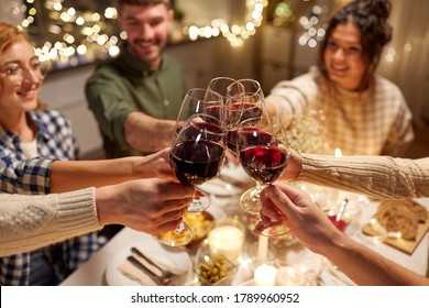 Holidays, Celebration And People Concept - Happy Friends Having Christmas Dinner At Home Drinking Non-alcoholic Red Wine