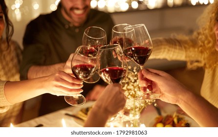 Holidays, Celebration And People Concept - Happy Friends Having Christmas Dinner At Home Drinking Non-alcoholic Red Wine