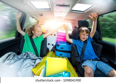 Holidays - Children relax in the car during a long car journey