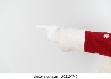 Holidays And Christmas Concept. Santa Claus Points With His Hand. No Face. Isolated On White