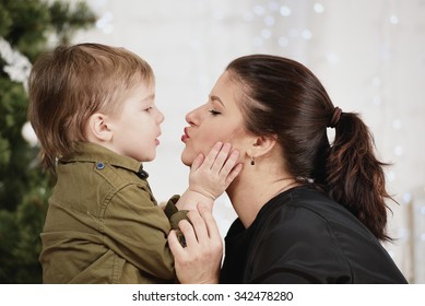 Holidays, christmas, love and happy family. Little boy kissing mother