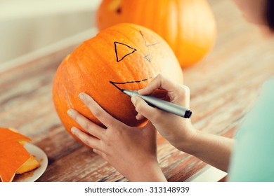 Holidays, Halloween, Decoration And People Concept - Close Up Of Woman With Pumpkins At Home