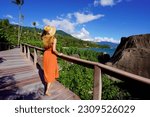 Holidays in Ilhabela, Brazil. Full length of young tourist woman on trail in Praia Pedra do Sino tropical beach in Ilhabela, Brazil.