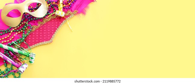 Holidays image of mardi gras and brazil masquarade carnival mask over yellow background. view from above