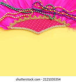Holidays image of mardi gras and brazil masquarade carnival decorations over yellow background. view from above