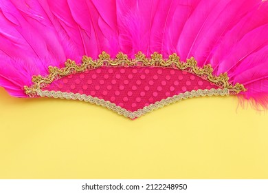 Holidays image of mardi gras and brazil masquarade carnival decoration over yellow background. view from above