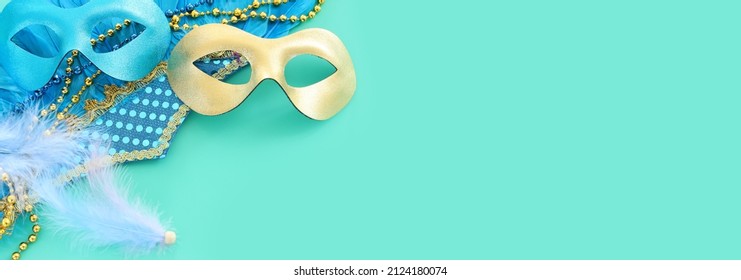 Holidays image of masquarade carnival masks over blue background. view from above