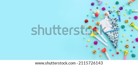 Holidays image of party colorful objects and cute clown over blue background. view from above. banner